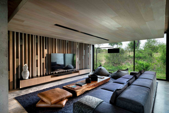 Cheetah Plains: Wohnlounge mit grauem Ecksofa und rustikalem Holztisch