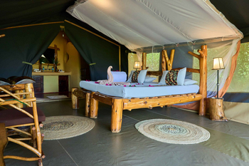 Ikoma Tented Camp: Bett mit Handtüchern und Blütenblättern