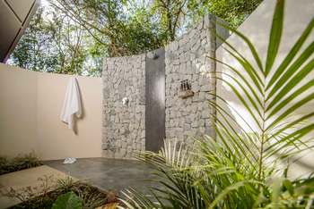 Savanna Lodge: Freiluftdusche mit Natursteinwänden und weißem Handtuch