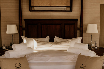 Otjiwa Thornbush Tented Camp: Doppelbett mit Holzkopfteil und gerollten Handtüchern