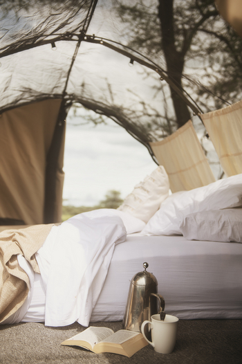 Wayo Walking Camp: Buch und Kaffee neben Schlafmatratze