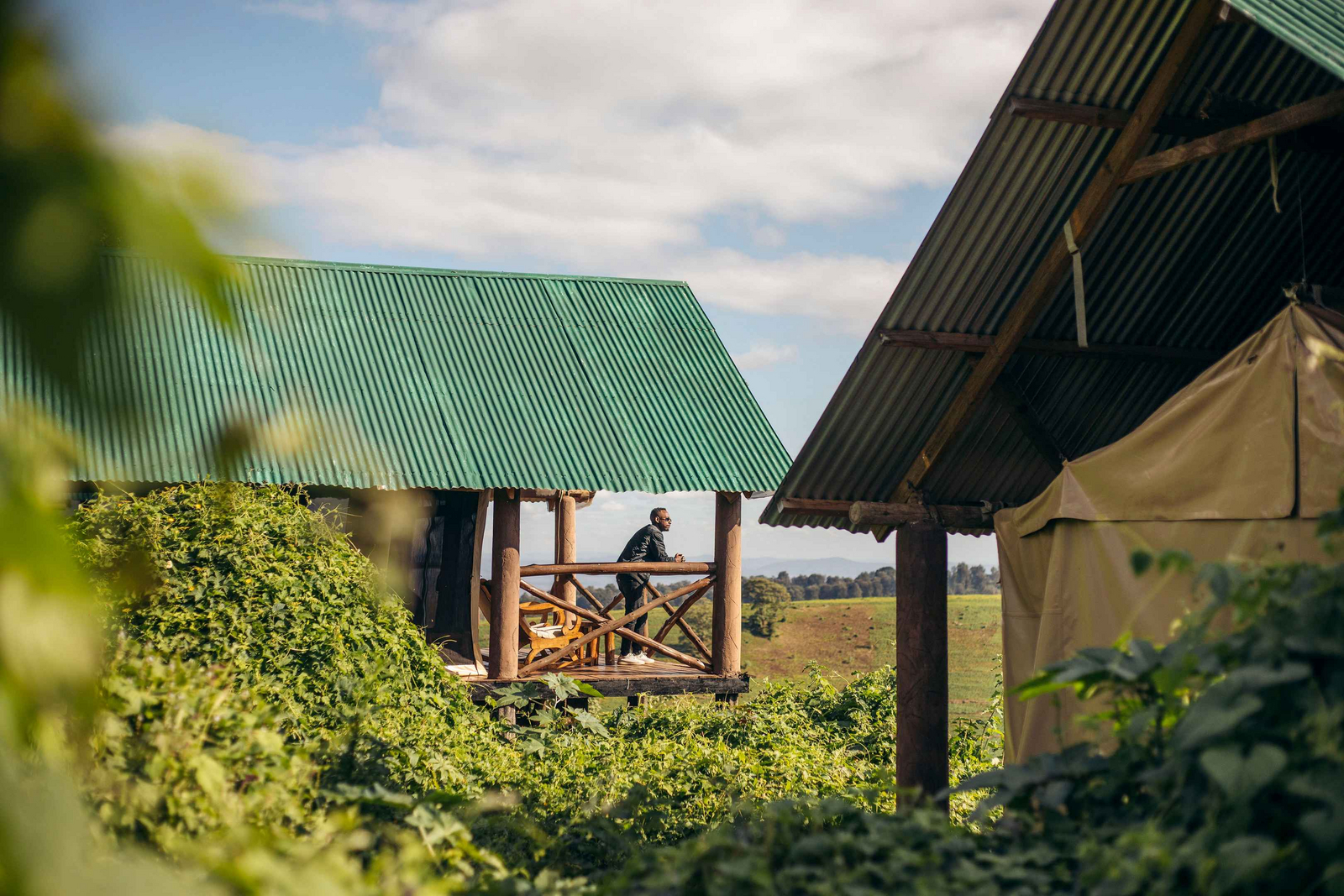 Crater Forest Tented Camp Crater Forest Tented Camp: Gast genießt Aussicht am Holzbalkon