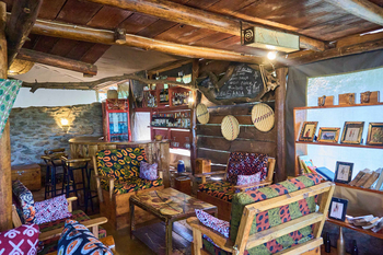 Ikoma Tented Camp: Gemütliche Lounge mit verzierten Kissen und Bar