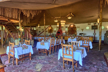 Ikoma Tented Camp: Rustikale Speisebereich mit weißen Tischdecken