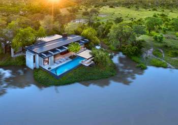 Cheetah Plains: Infinity-Pool mit badendem Gast am Buschfluss