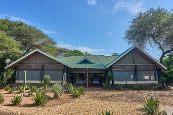 Ikoma Tented Camp: Elegant Dining Setup Under Tented Canopy