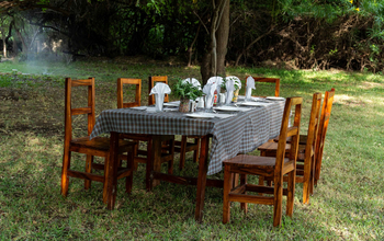 Lake Natron Tented Camp: Outdoor Dining with Rustic Wooden Table
