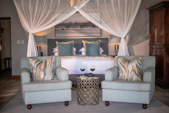 Savanna Lodge: Schlafzimmer mit Moskitonetz und Weingläsern