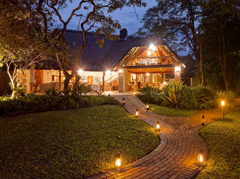 Savanna Lodge: Offene Lounge mit laternenbeleuchtetem Pfad