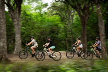 andBeyond Phinda Forest Lodge: Lächelnde Gäste auf E-Bikes im Wald