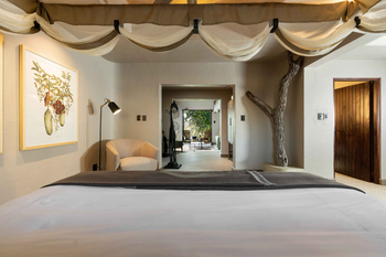Sabi Sabi Bush Lodge: Schlafzimmer mit Holzzweig-Element und Kunstwerk